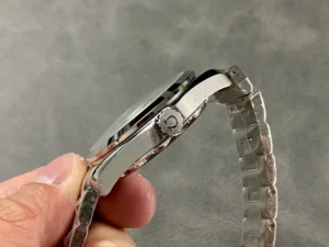 Crown side held between fingers