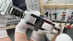 Folding clasp opened in a gloved hand