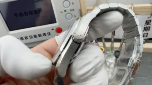 Crown side held in a gloved hand on a workbench