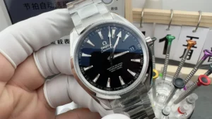 Omega Aqua Terra 231.10.39.21.01.002 in a gloved hand on the workbench