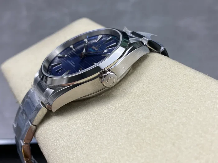 Crown side on the cushion, blue dial at an angle, blue Aqua Terra, cushion set