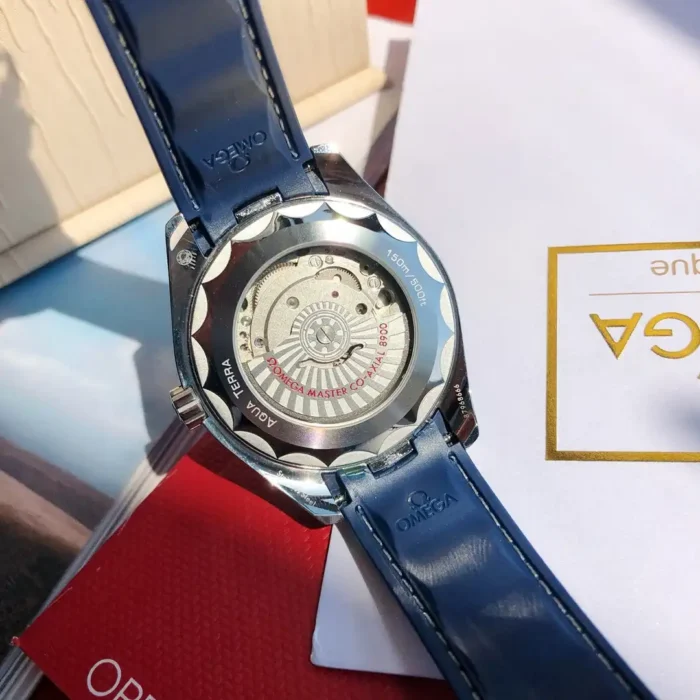 Display caseback with the rotor, strap lying on red paper