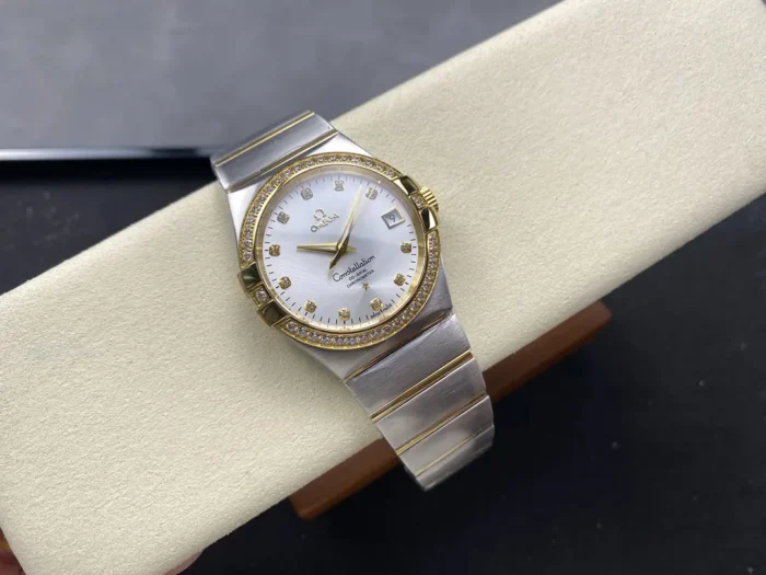 The two-tone 38mm silver dial model on a cushion at an angle