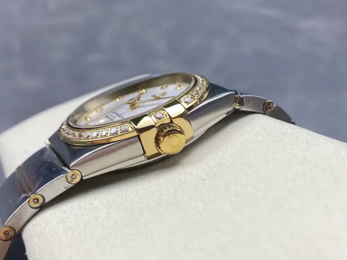 Crown side of the two-tone 38mm silver dial model, gold tone crown between the claws