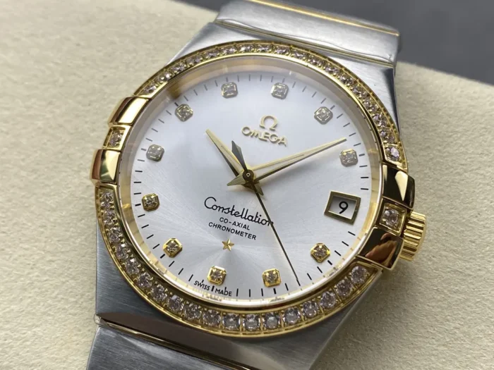 Silver sunray dial seen from the left, stone set yellow gold tone bezel in view