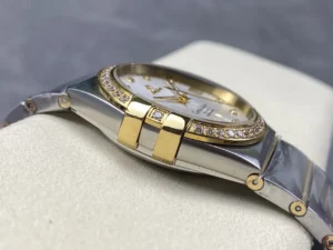 Left side of the two-tone 38mm silver dial model, one of the stone set gold tone claws by the bezel