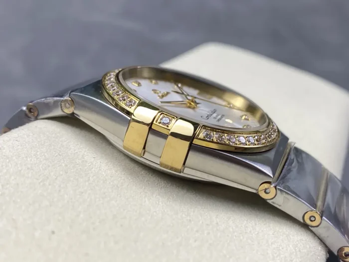 Left side of the two-tone 38mm silver dial model, one of the stone set gold tone claws by the bezel