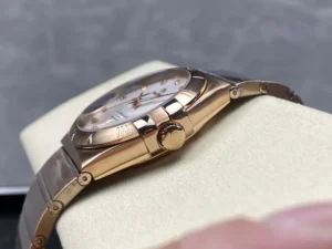Crown side of the rose gold tone 38mm stone model, rose gold tone crown between the claws