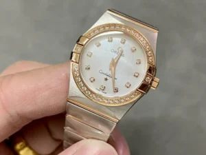 White mother of pearl dial seen from the left, stone set rose gold tone bezel in view