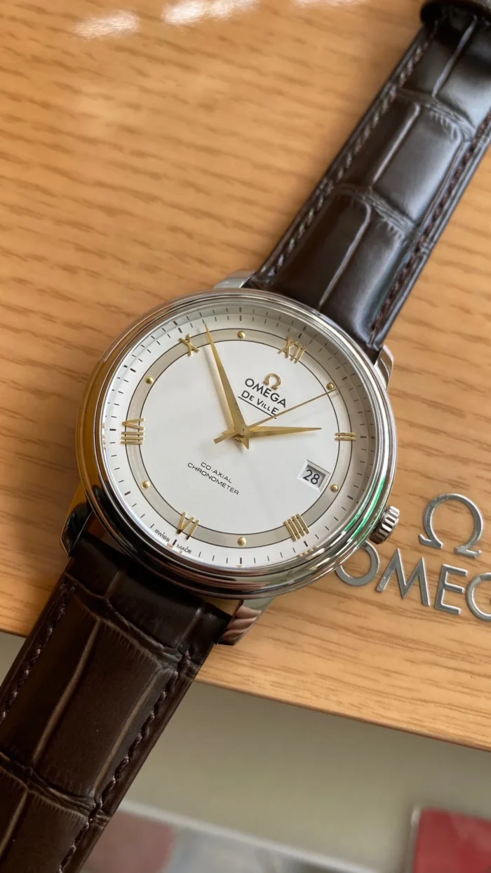 Dial at an angle above the Omega logo on the box
