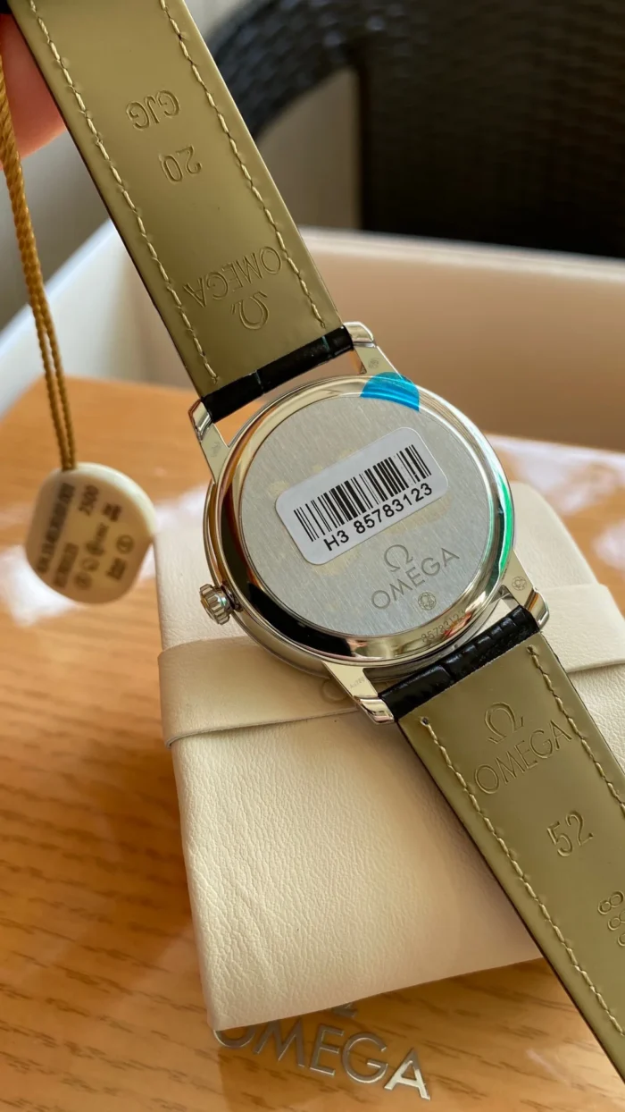 Caseback with a barcode sticker on a cushion, olive strap lining