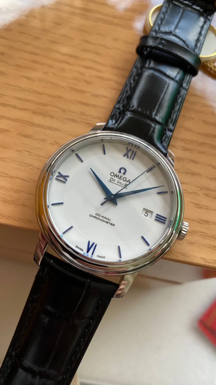 White dial with blue Roman numerals on a wooden box