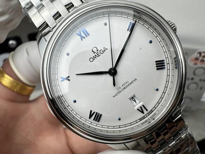 Macro of the white dial, blue Roman numerals and slim dark blue hands
