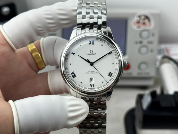 Held in a glove, white dial with blue Roman numerals