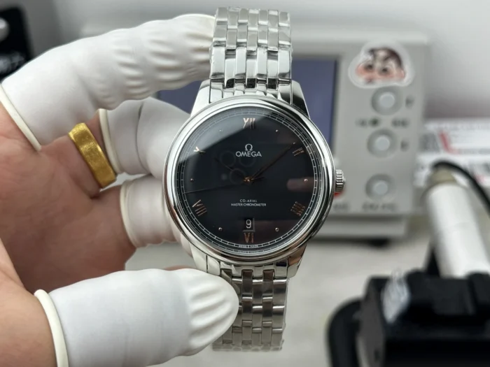Held in hand, rose gold tone numerals on the black dial