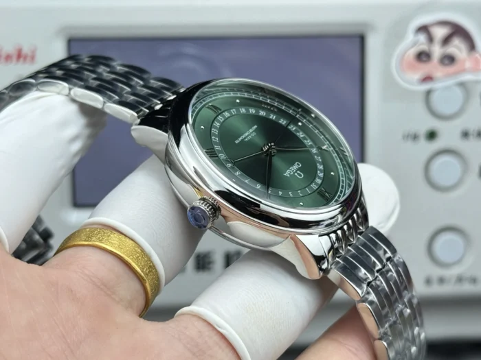 Crown side of the green dial Prestige held in a glove