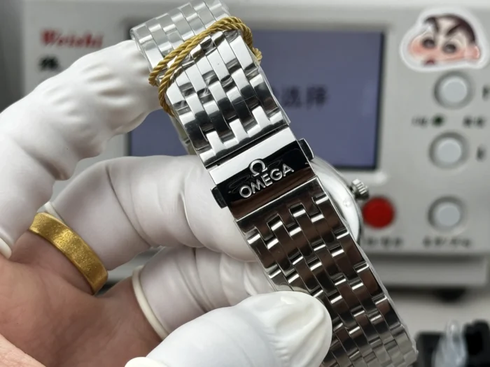 Omega engraved clasp with the tag cord around the links