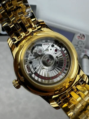 Display caseback with red rotor lettering in a gold tone case