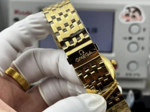 Gold tone clasp engraved with the Omega logo