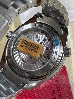 Display caseback with a barcode sticker, red card underneath