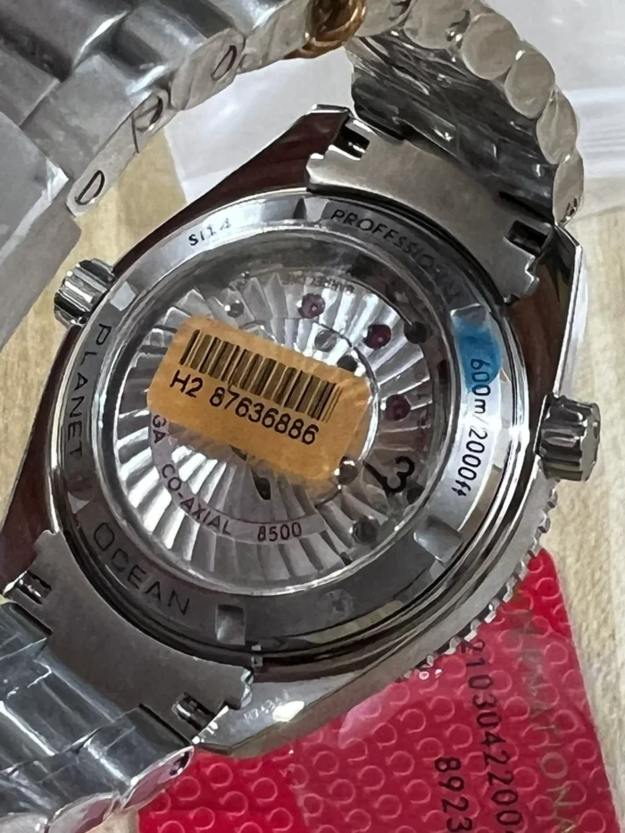 Display caseback with a barcode sticker, red card underneath