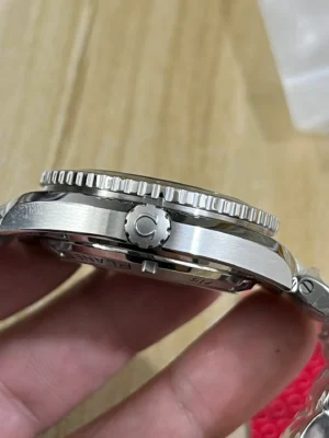 Crown side profile in hand, ridged bezel edge