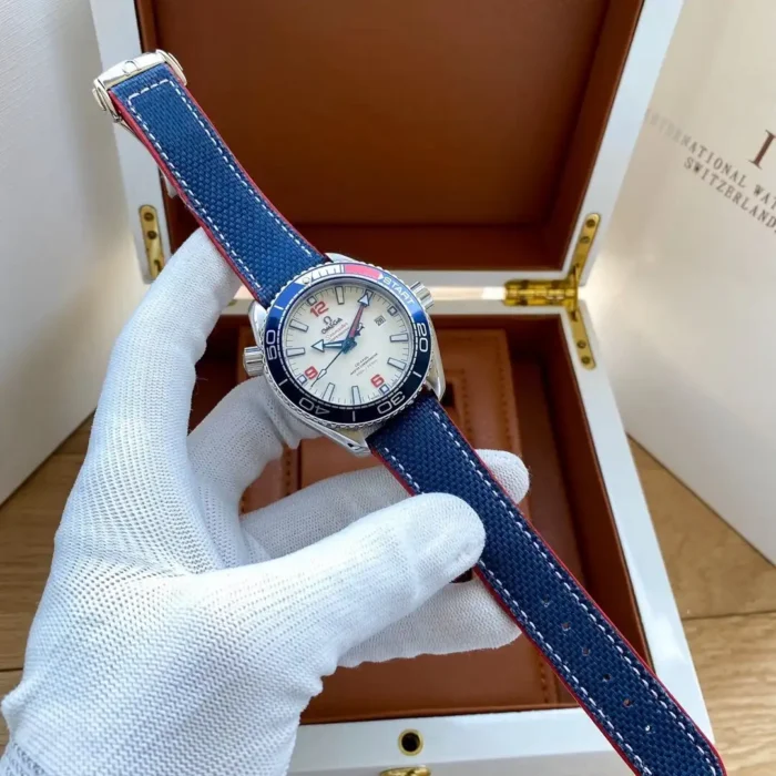 Held in a gloved hand above an open wooden box