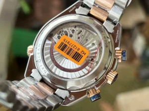 Display caseback with an orange barcode sticker, two tone Planet Ocean chronograph