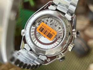 Display caseback with an orange barcode sticker, black Planet Ocean chronograph