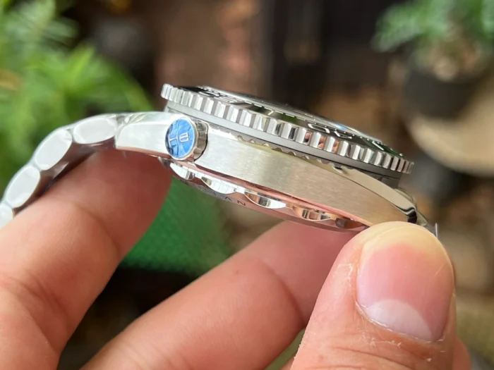Case side with the valve, ridged bezel edge, black Planet Ocean chronograph