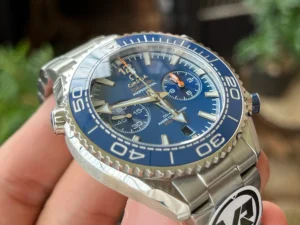 Dial at an angle in hand, blue bezel numerals
