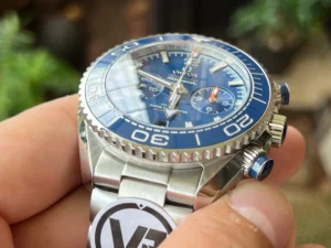 Crown and blue pushers seen from the side, in hand