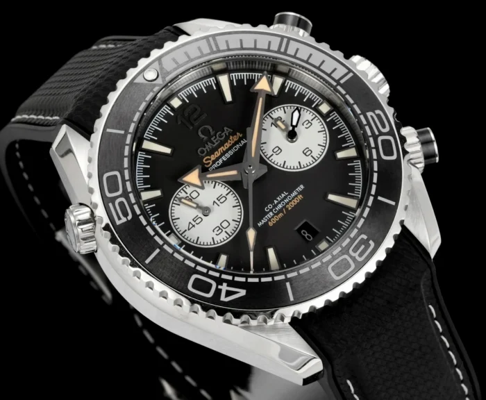 Watch angled to the left on black, beige tipped hands
