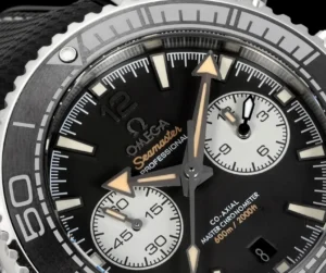 Macro of the dial: white subdials and orange Seamaster script