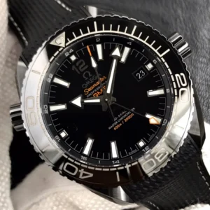 Close-up of the black dial, orange GMT text and orange-tipped hand