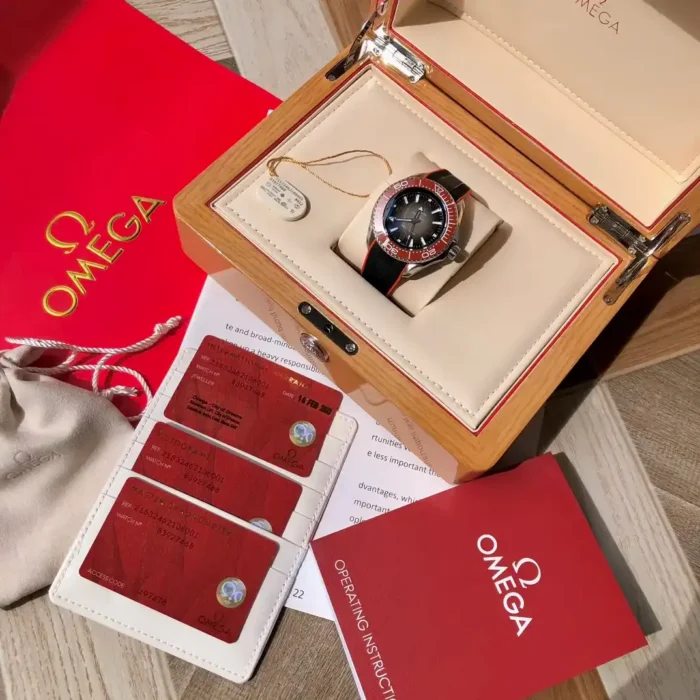 Open wooden box with the watch, cards and booklets around it