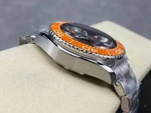 Case profile on the side opposite the crown, orange bezel