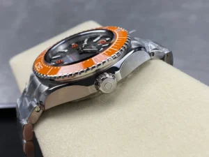 Crown side on the cushion, orange bezel edge