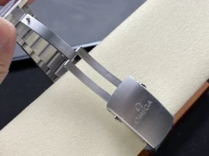 Folding clasp opened over the cushion, Omega logo on the cover