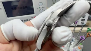 Case side held in finger cots, mesh bracelet behind