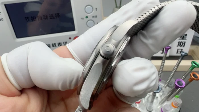 Case side held in finger cots, mesh bracelet behind