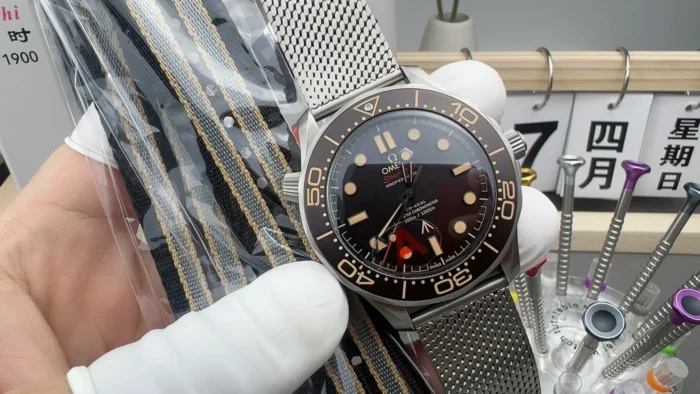 Dial next to a bagged NATO strap with tan stripes
