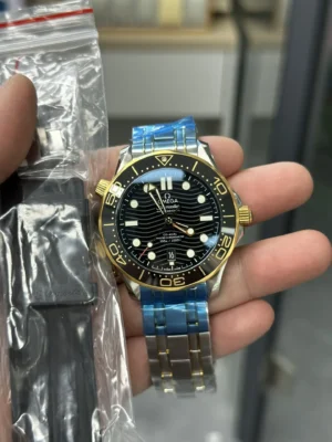 Watch in hand next to a clear bag with a black rubber strap