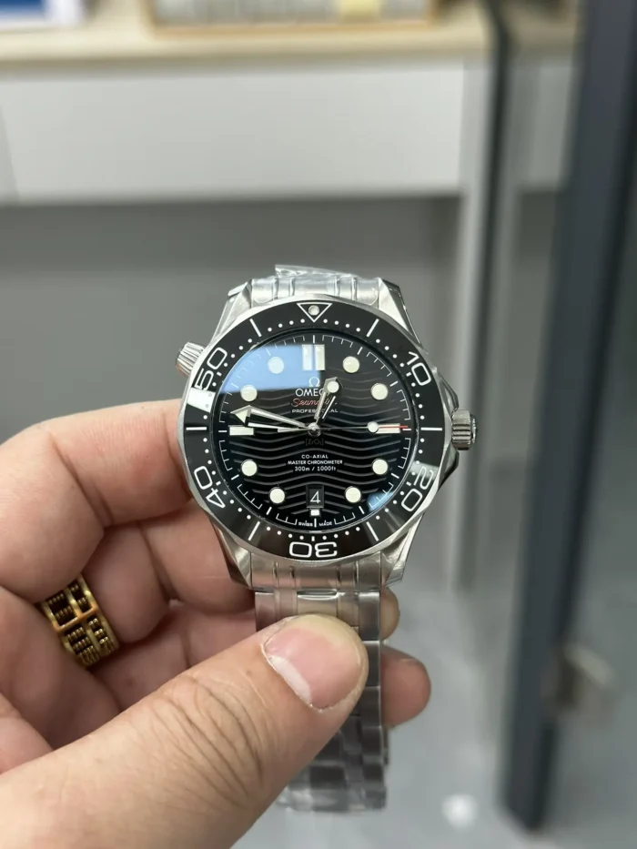 Black wave dial in hand with a blue reflection on the crystal