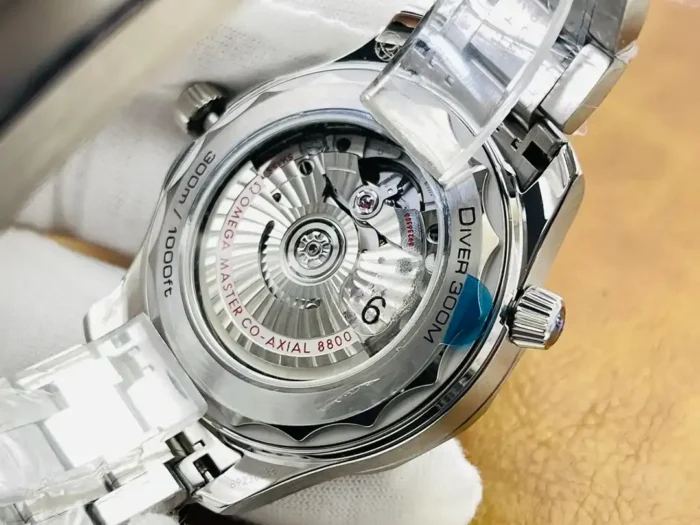 Clear caseback in a white glove, rotor and Diver 300M text