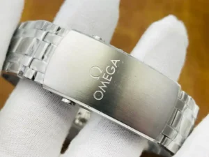 Closed clasp engraved Omega, held in a white glove