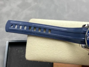 Blue rubber strap with adjustment holes over the cushion