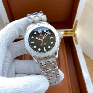 Bracelet version held over the open box, dial facing up
