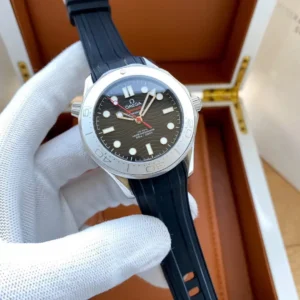 Black wave dial with red seconds hand, open wooden box behind
