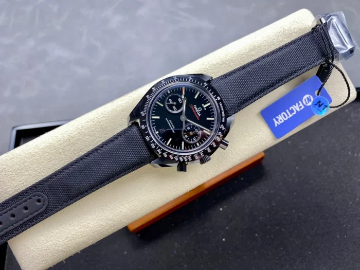 Whole watch laid on a cushion, black fabric strap and blue tag